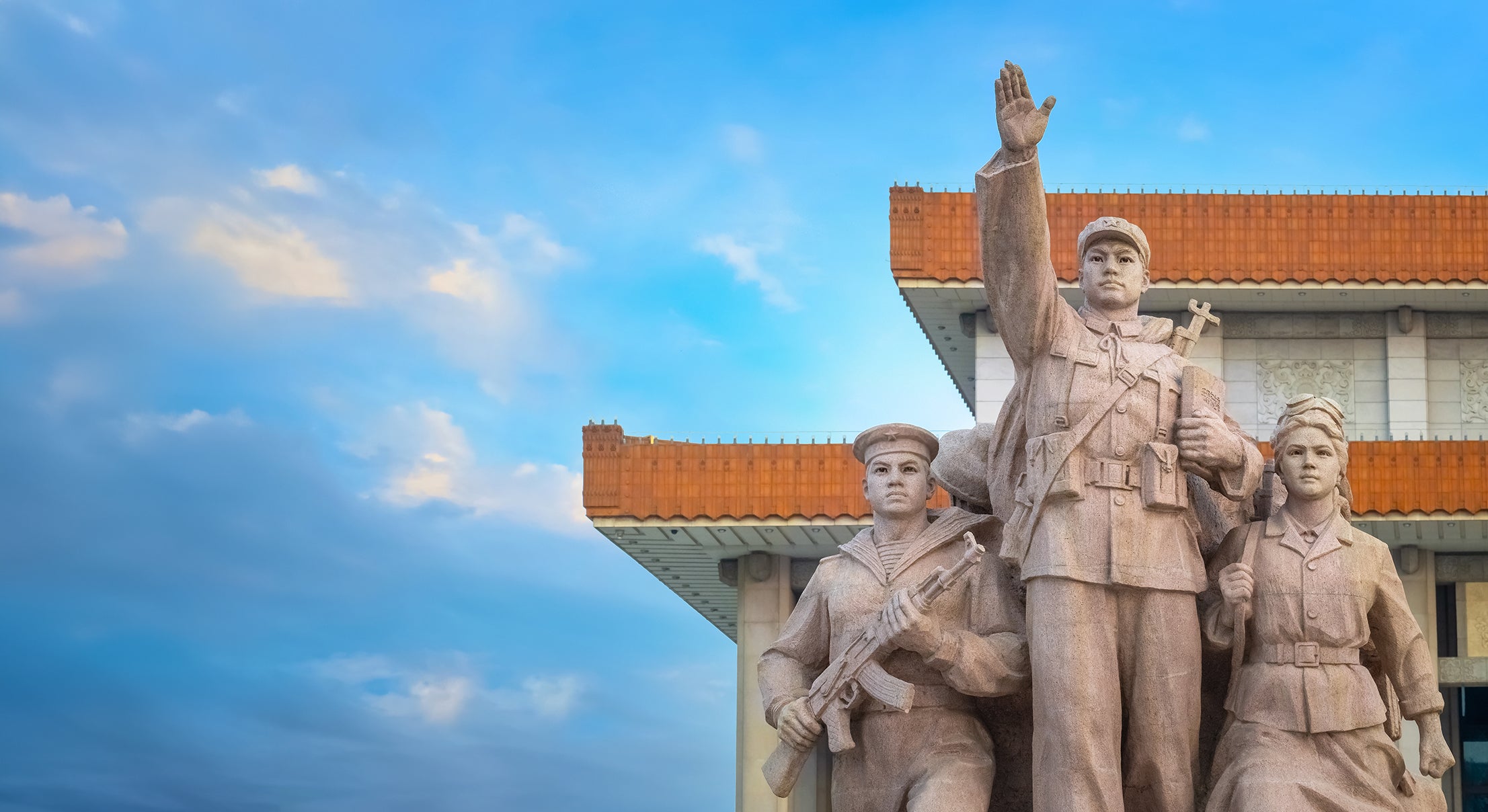Statue of three historical Chinese military figures in front of a building
