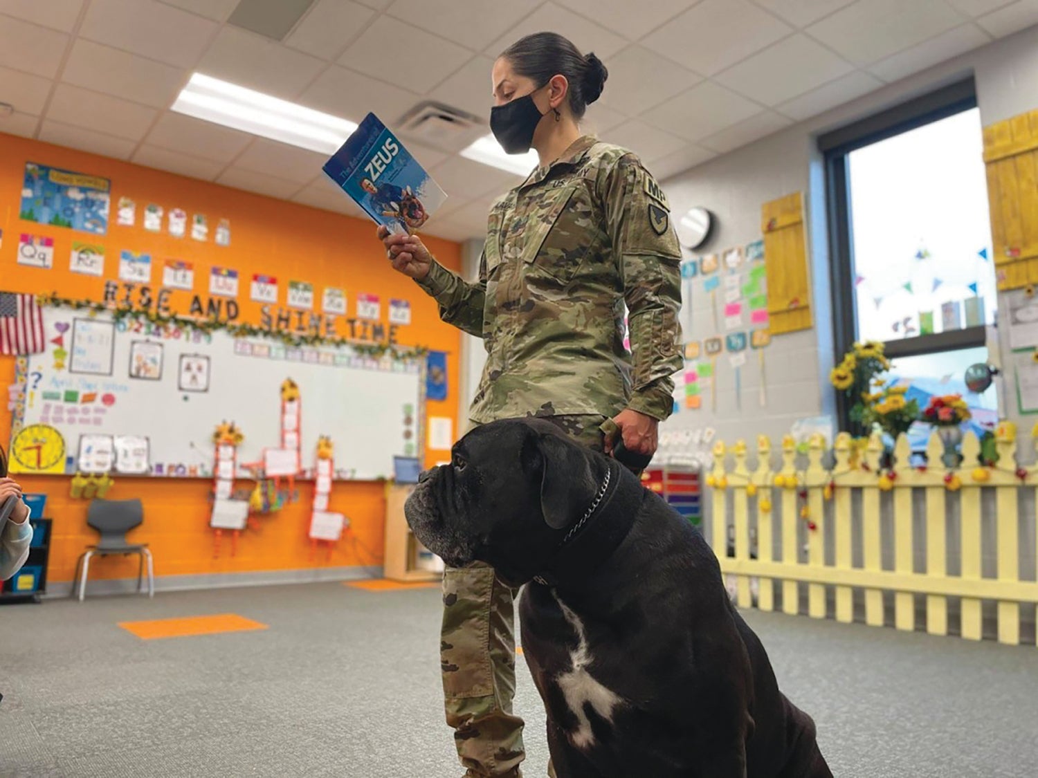 Sgt. Maj. Viridiana Lavalle, Army Military Working Dog Program manager, reads a book about military working dogs to elementary school students at Fort Sill, Oklahoma. (Credit: U.S. Army)