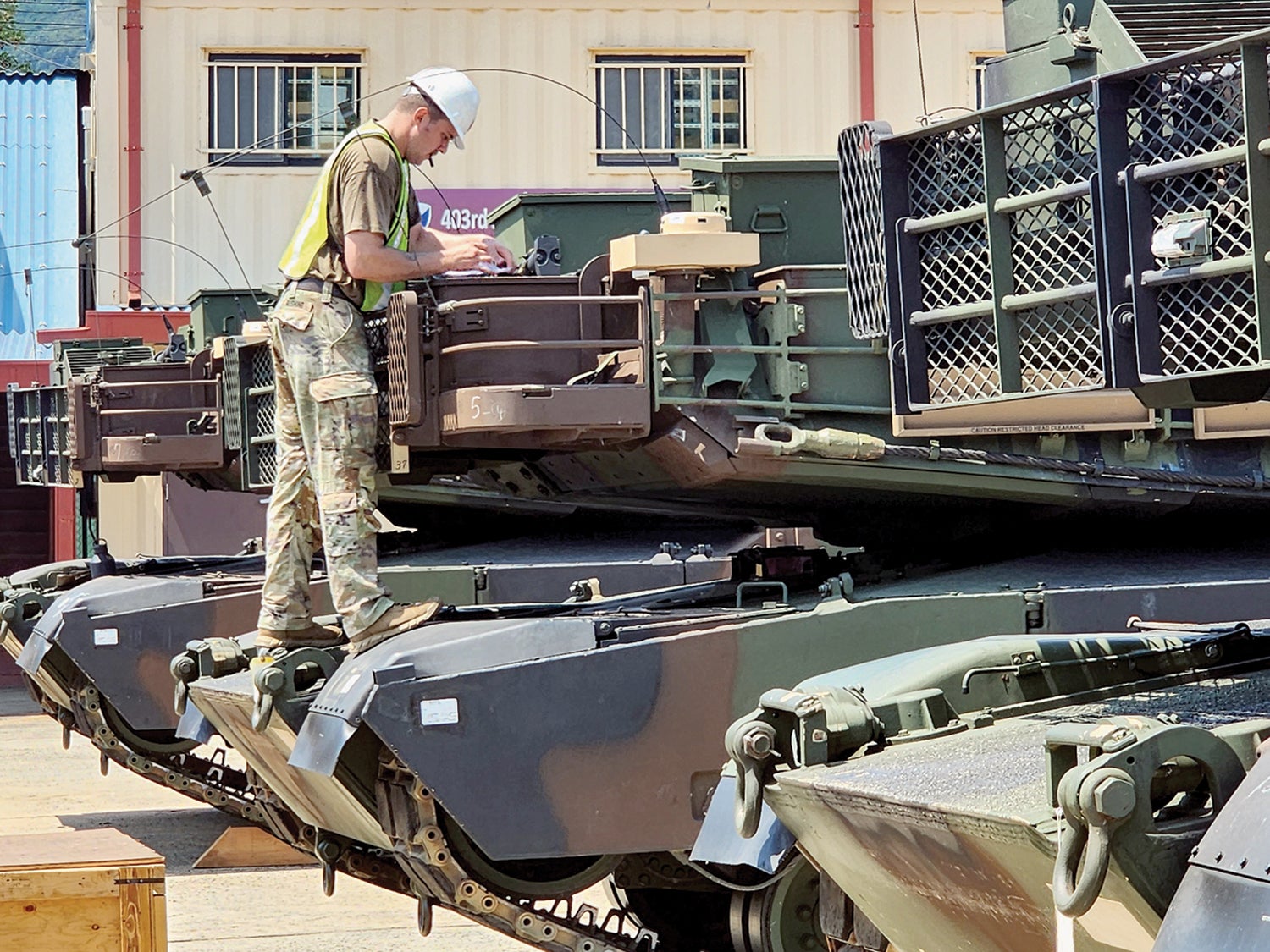 A soldier from the 1st Battalion, 77th Armor Regiment, conducts inventory and preventive maintenance checks on an M1A2 Abrams tank. (Credit: U.S. Army/Capt. Nathan Mumford)