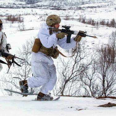 two soldiers running in the snow