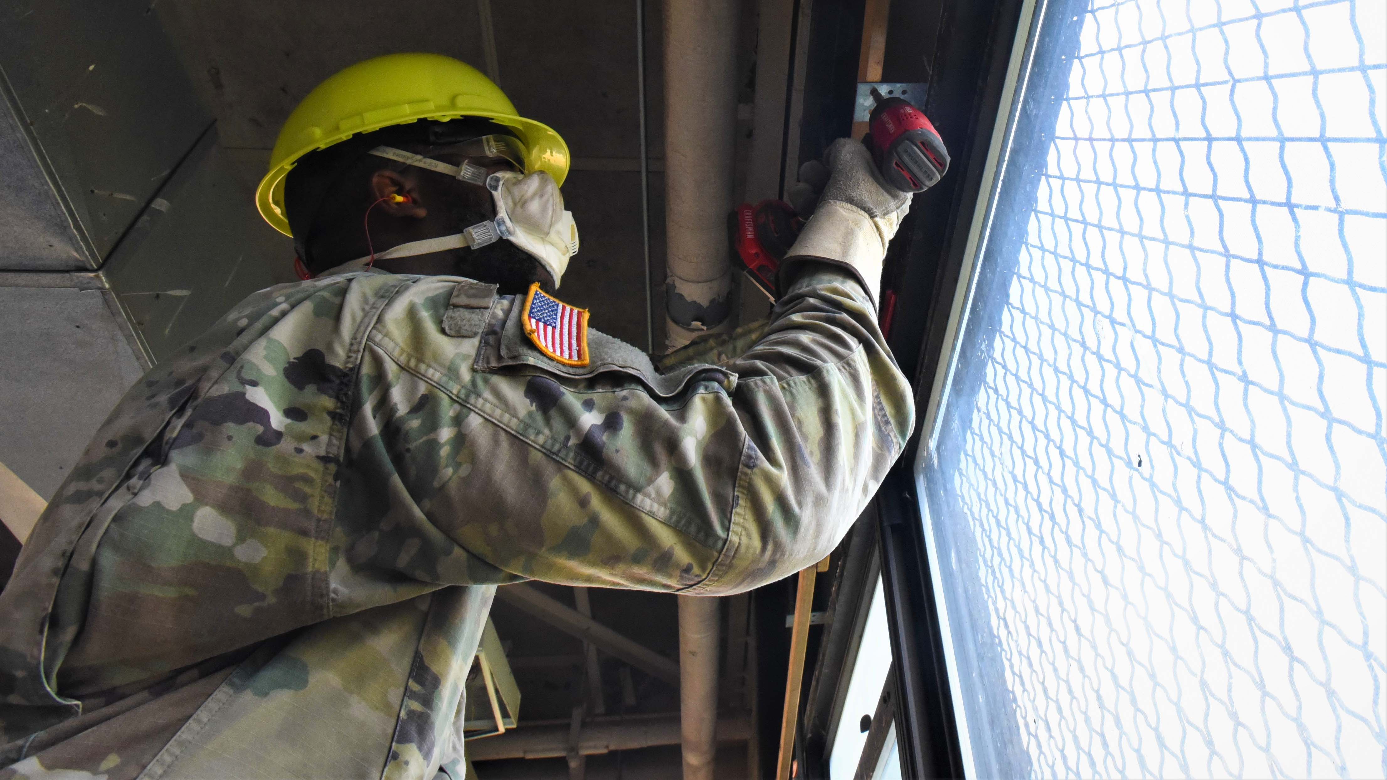 Soldier performing building maintenance