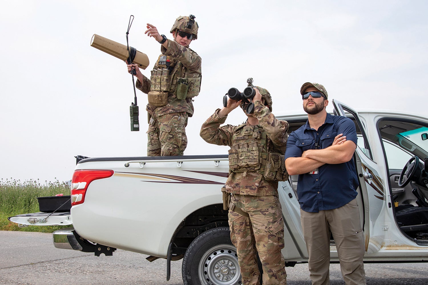 Sgt. Gentry Squier, left, points out a drone to Sgt. Gage Stancell during training at Erbil Air Base, Iraq. (Credit: U.S./Spc. Angel Ruszkiewicz)