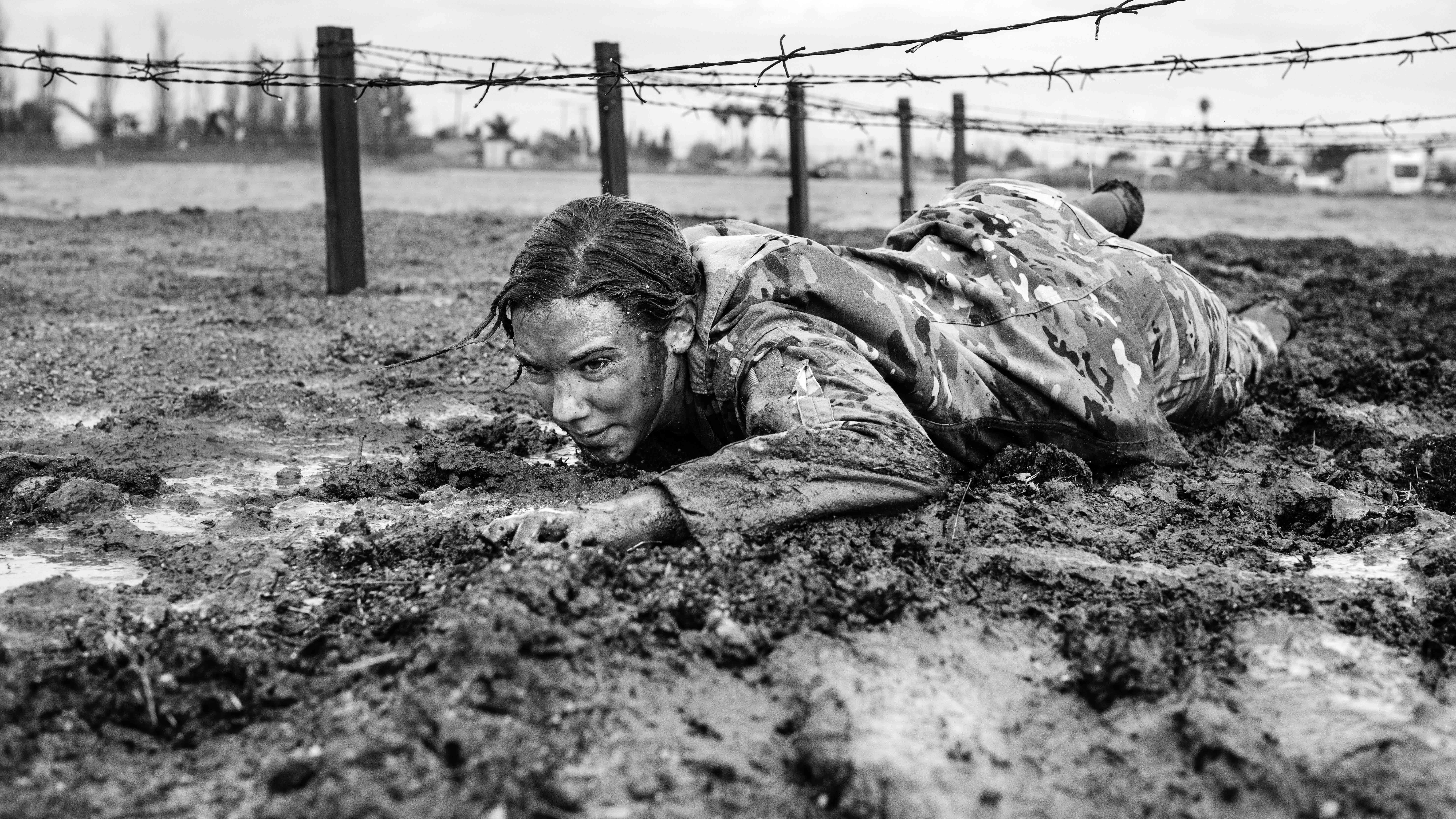 Soldier crawling through mud