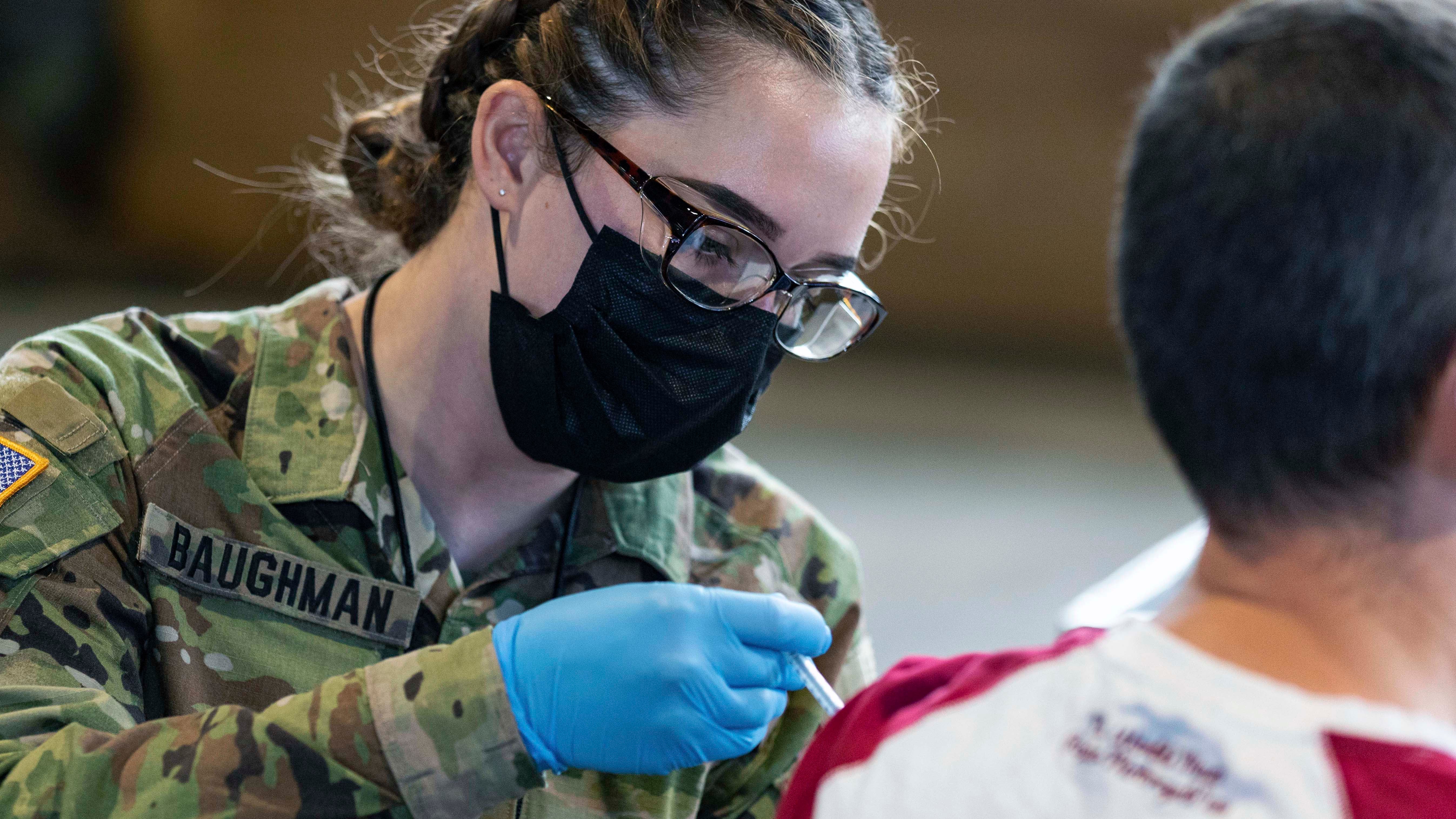 soldier giving vaccine