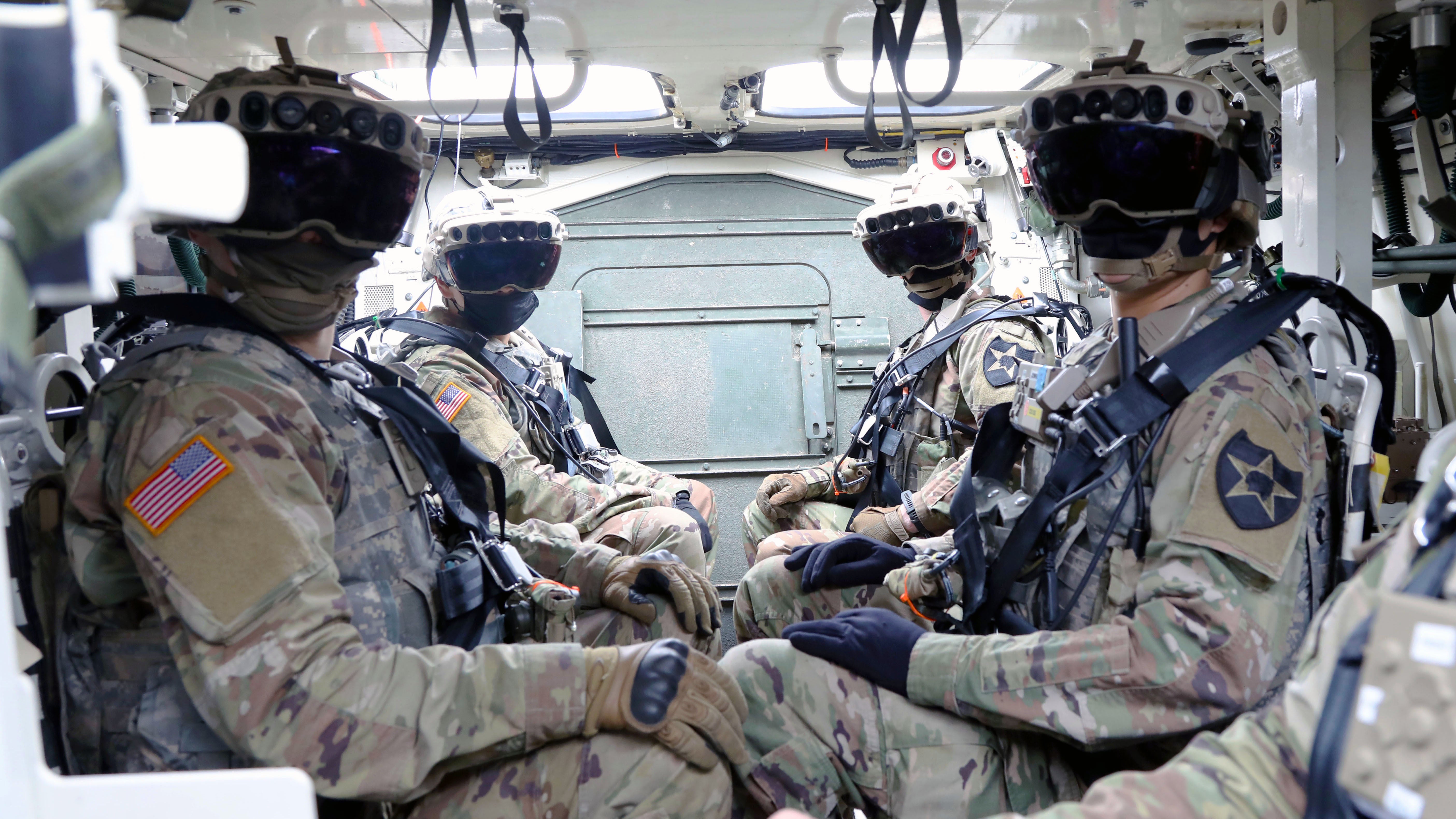 Soldiers sitting in a stryker wearing IVAS