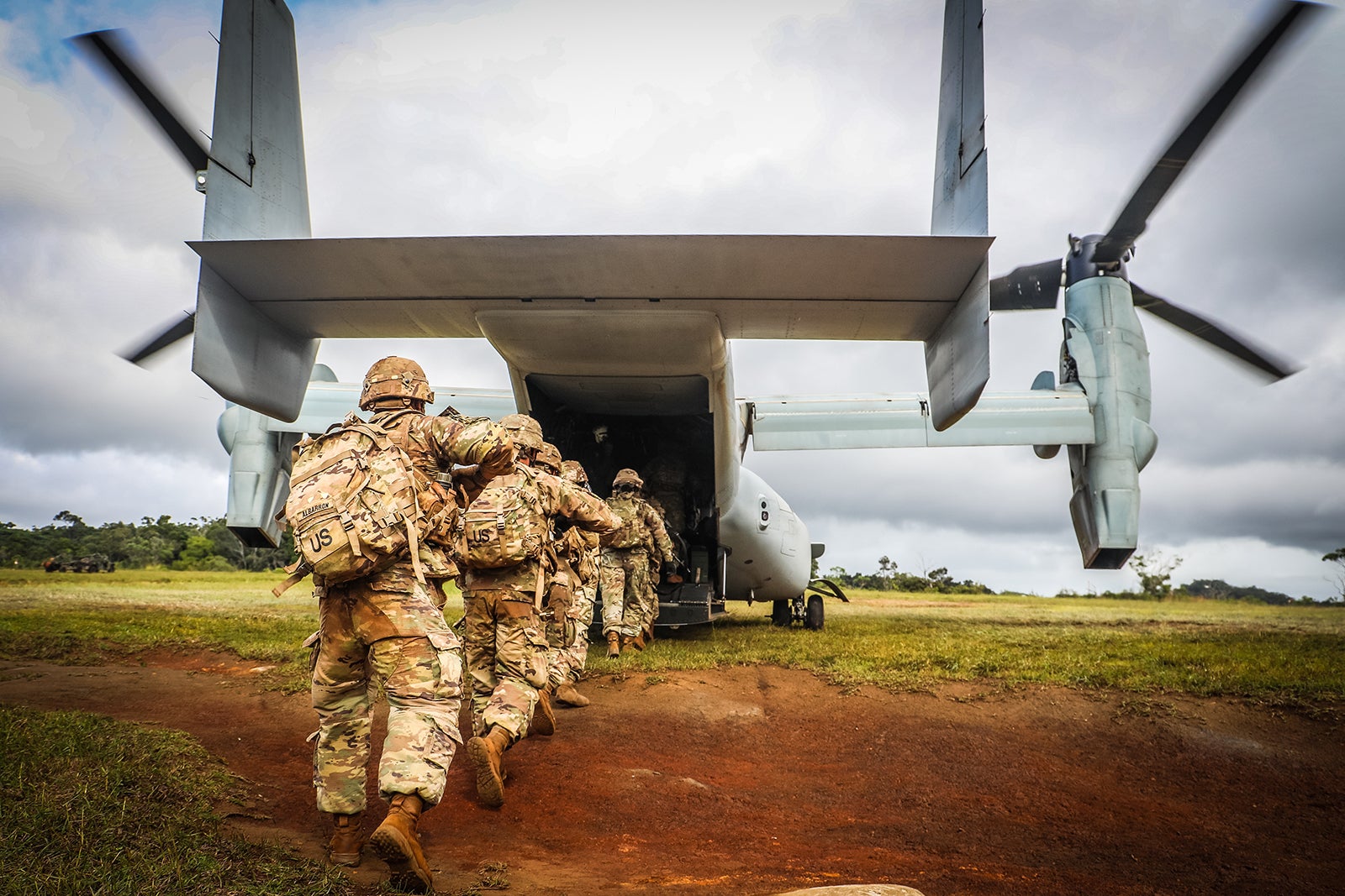 U.S. Army Soldiers boarding a Marine V-22 Osprey