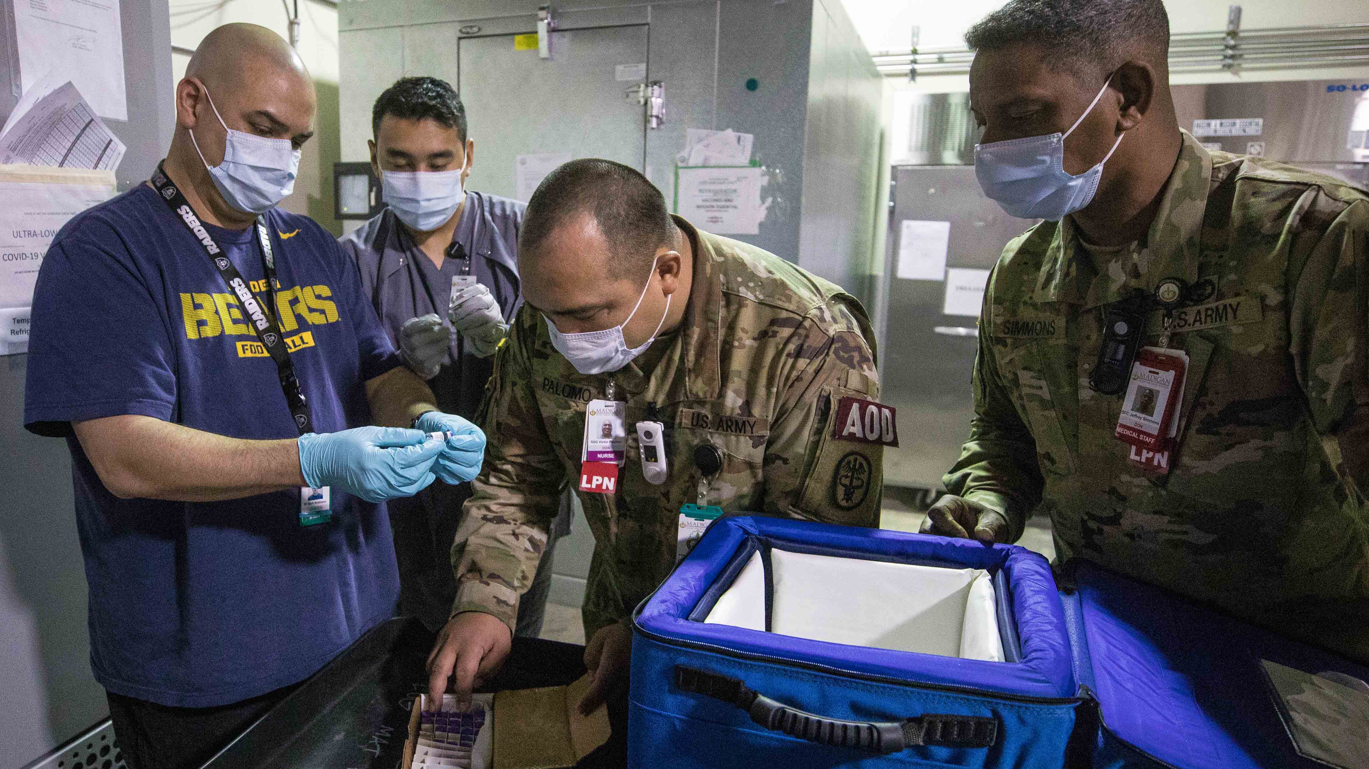 Soldiers aiding medical professionals