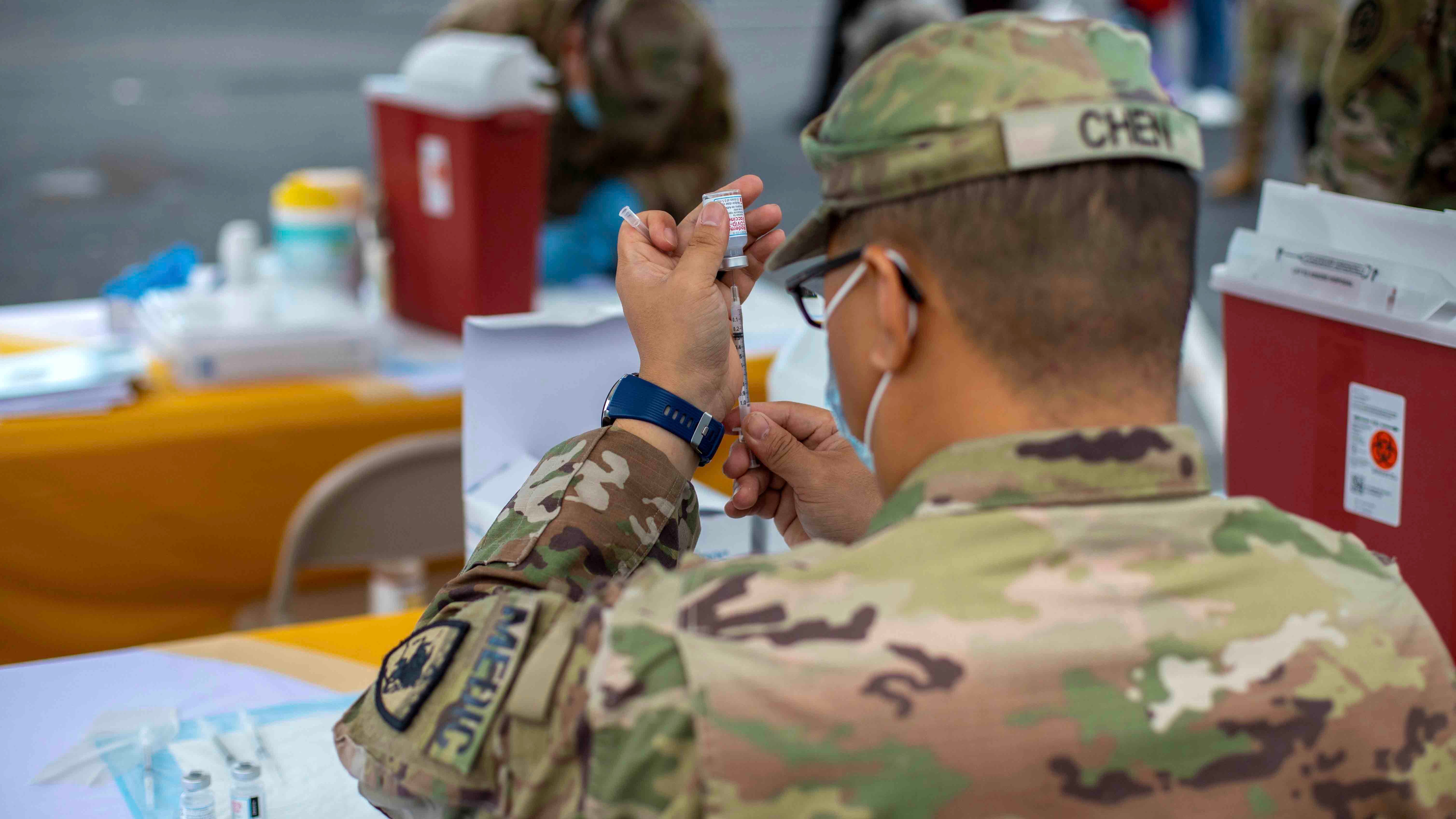 Guard Soldier giving vaccine