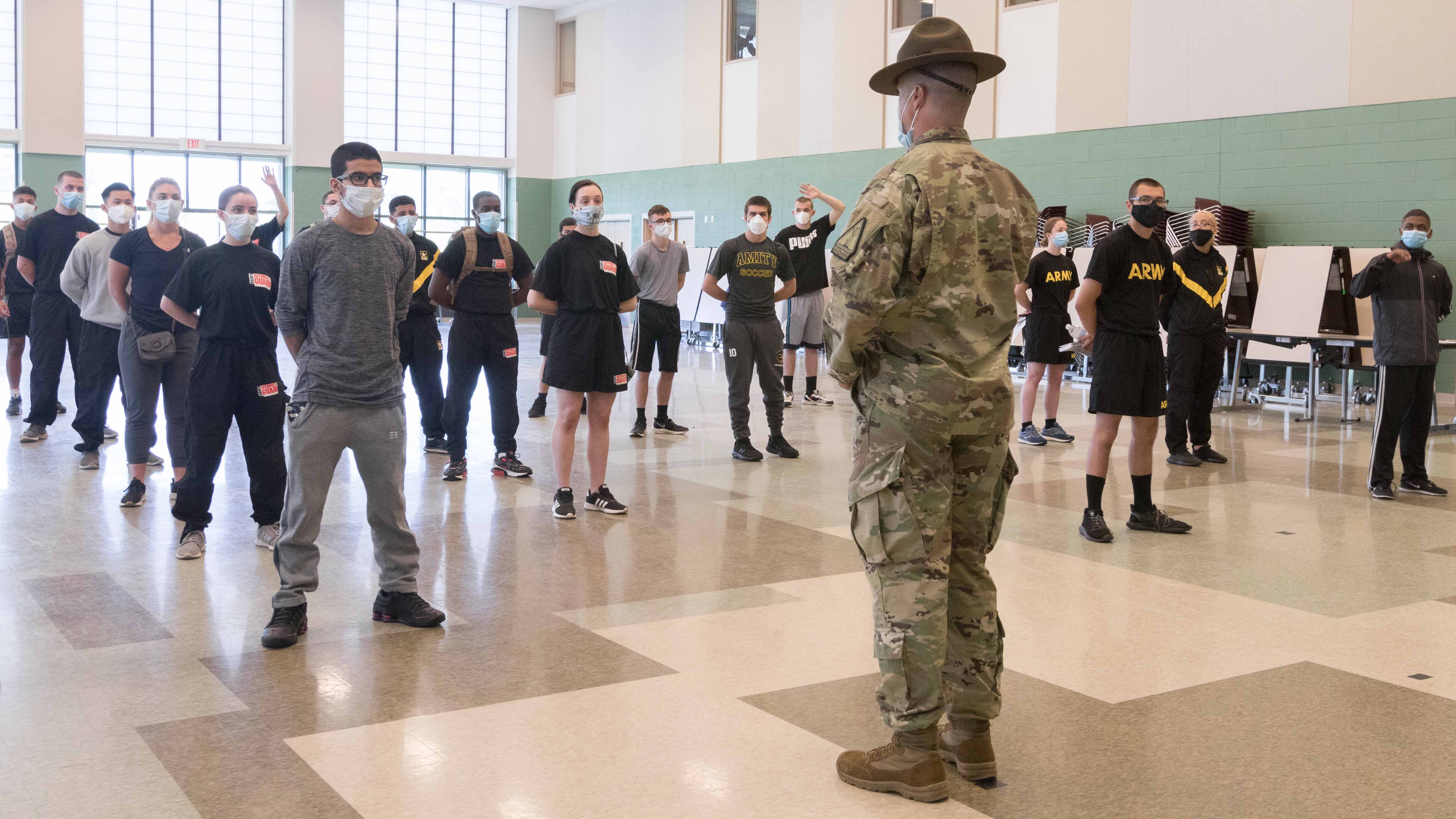 Recruits gather before a drill sergeant