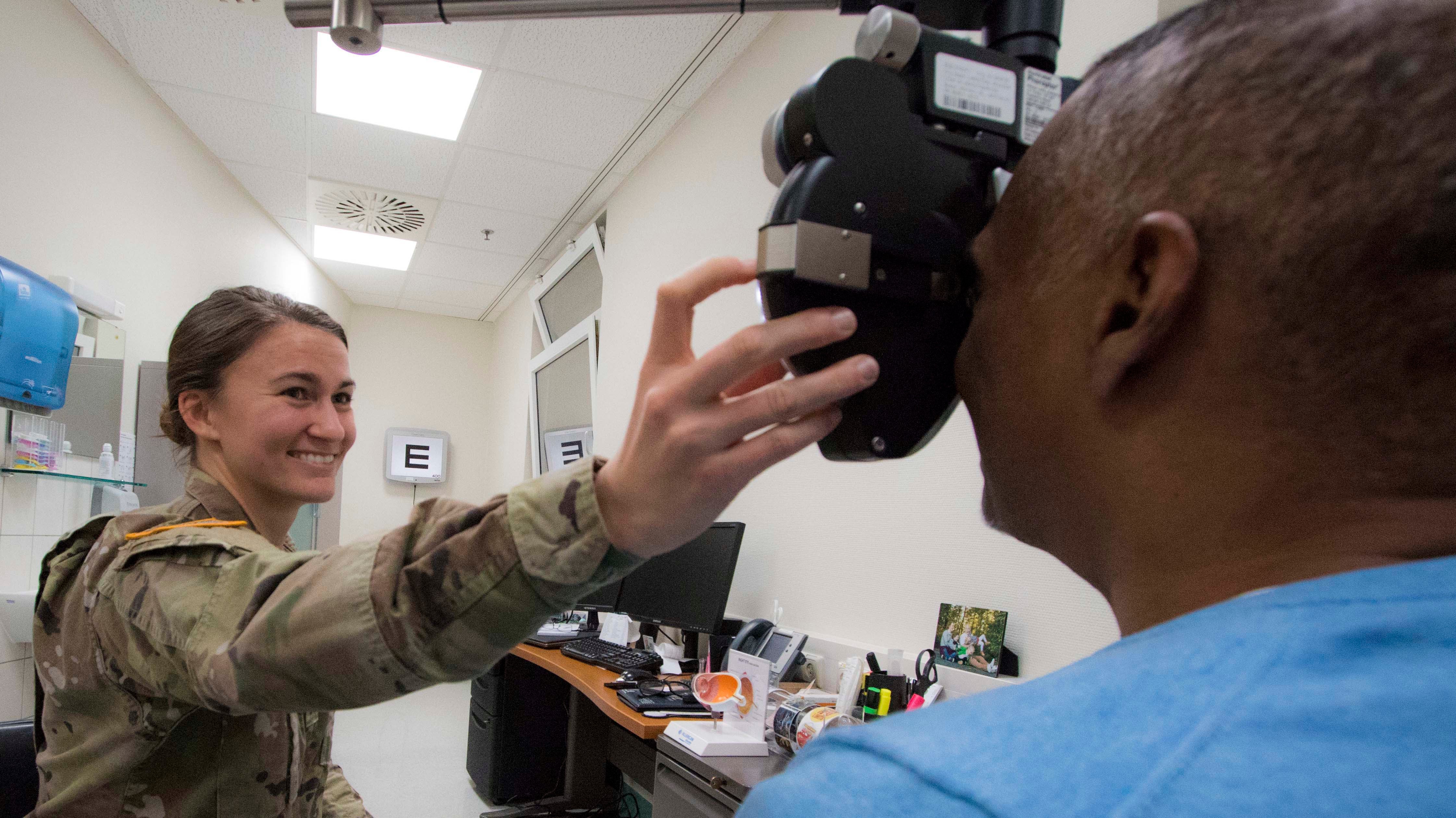 Soldier giving eye exam