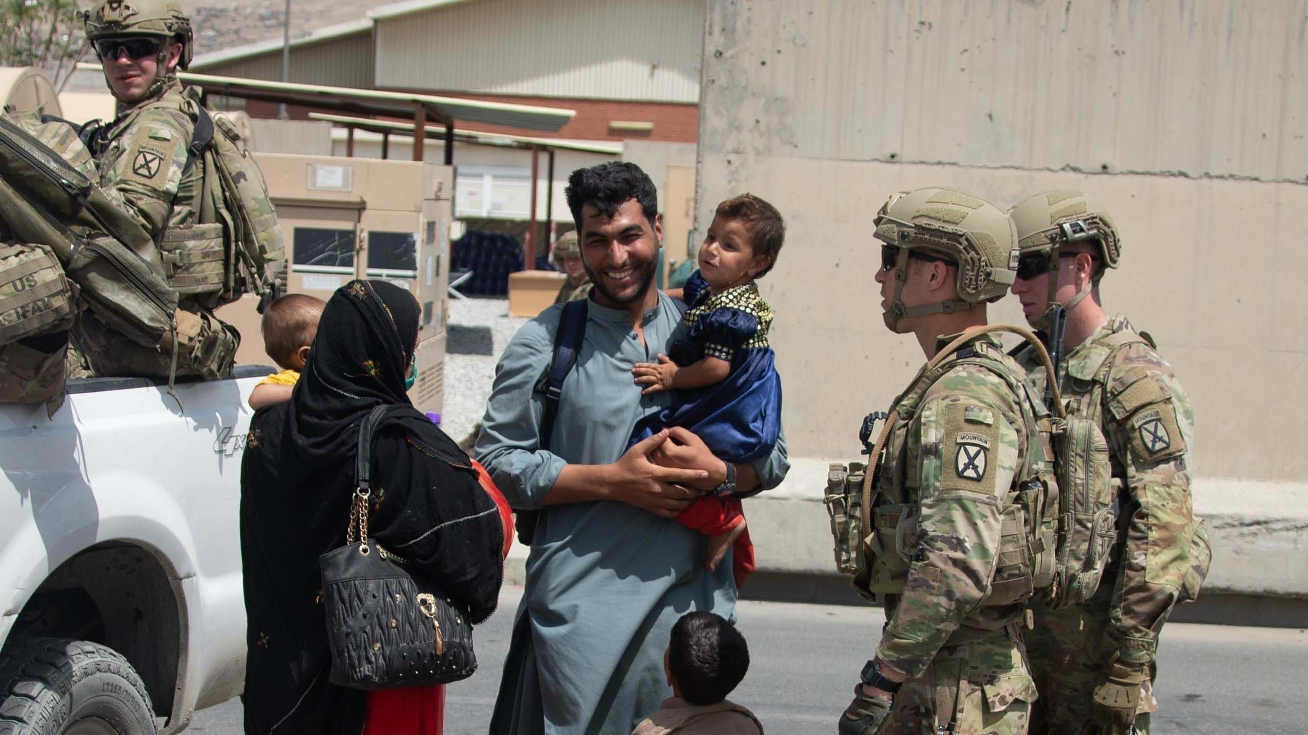 Soldiers talk to an Afghan family during the withdrawal.