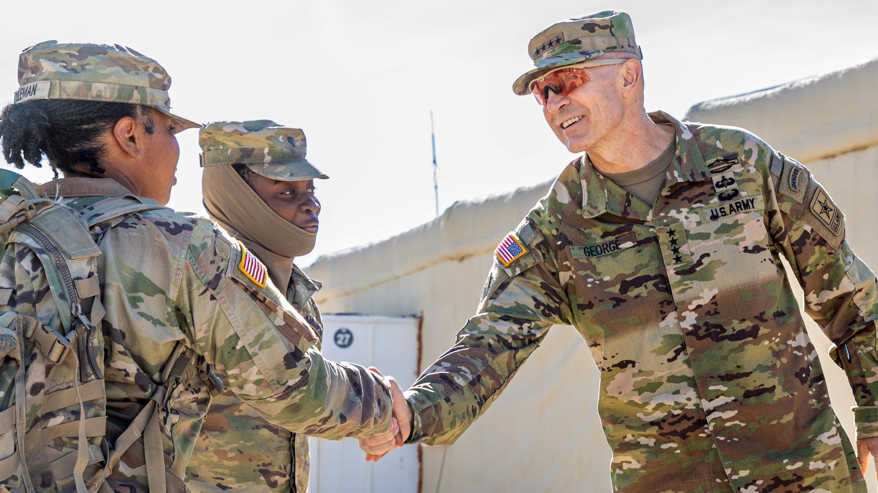 Gen George shaking a soldier's hand