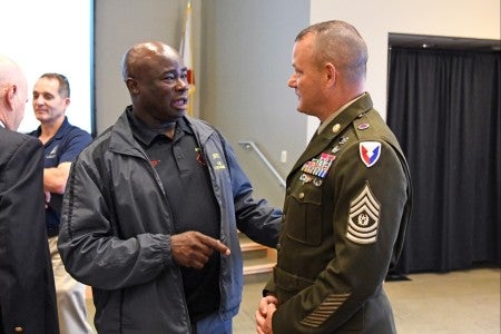 Aviation and Missile Command Sgt. Maj. Bradford Smith speaks with the JROTC instructor for Colombia High School, Command Sgt. Maj. Nathaniel Bartee Sr., at the Redstone-Huntsville chapter of AUSA breakfast held July 12, in Huntsville, Ala. 