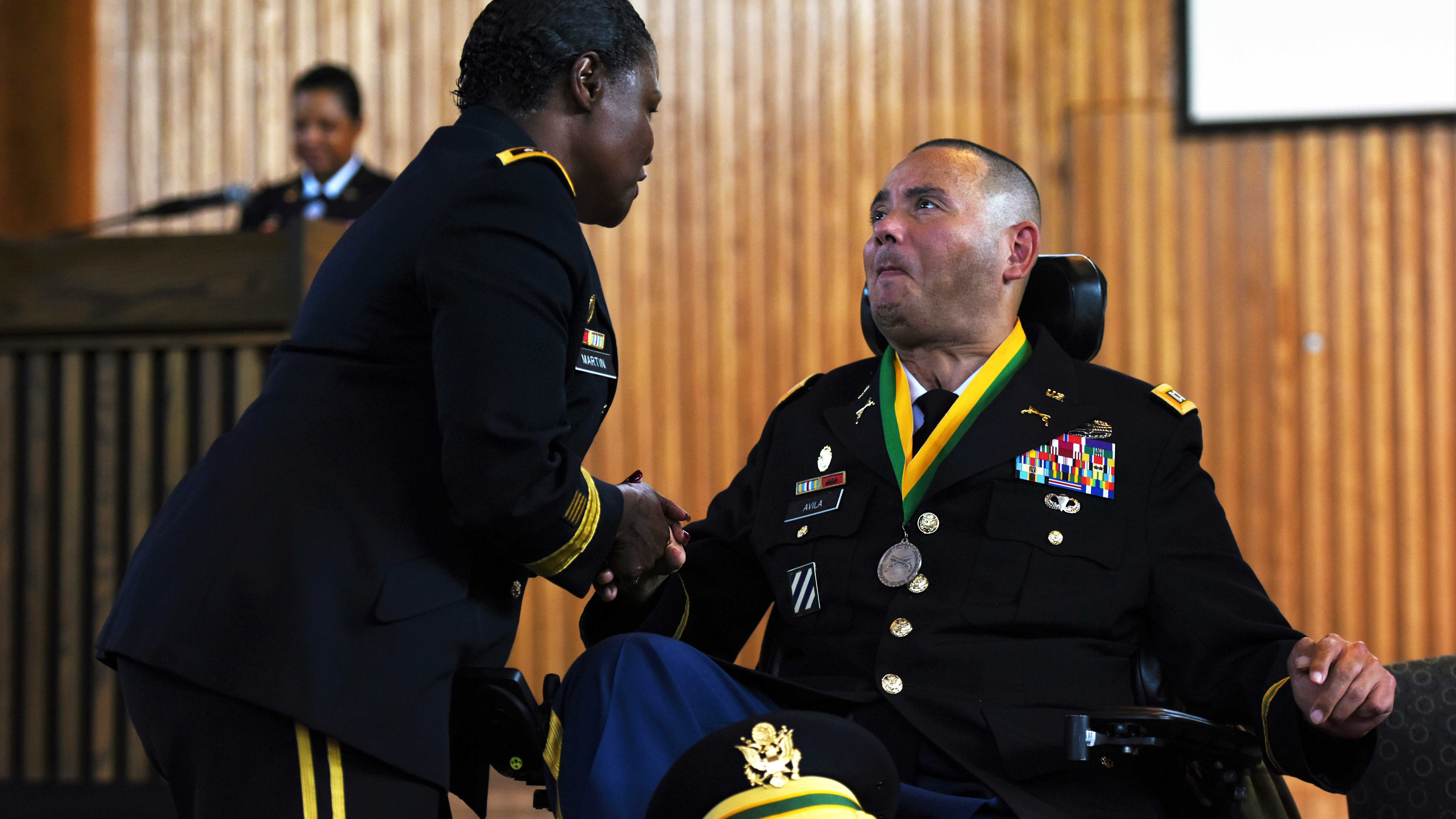 Capt. Luis Avila receives award from Army Inspector General Lt. Gen. Donna Martin