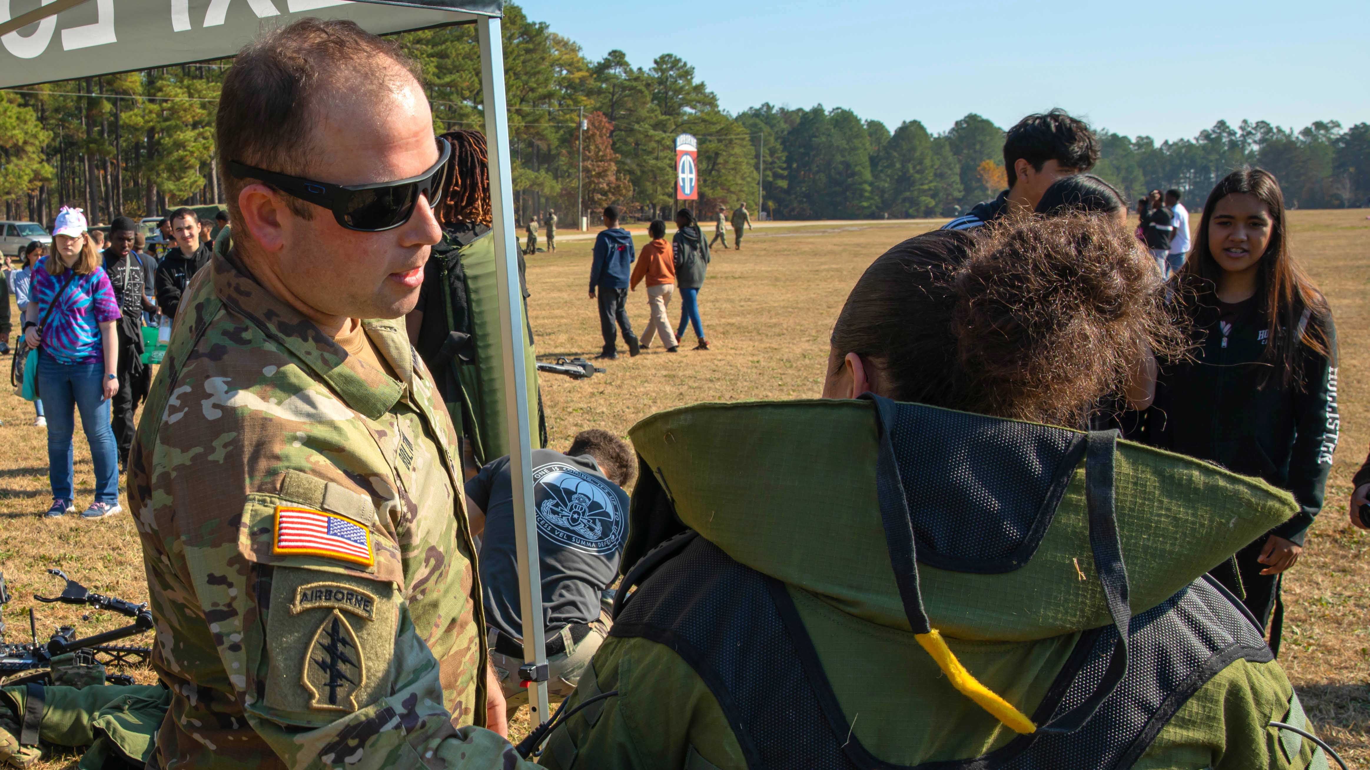 Soldier showing equipment to potential recruit