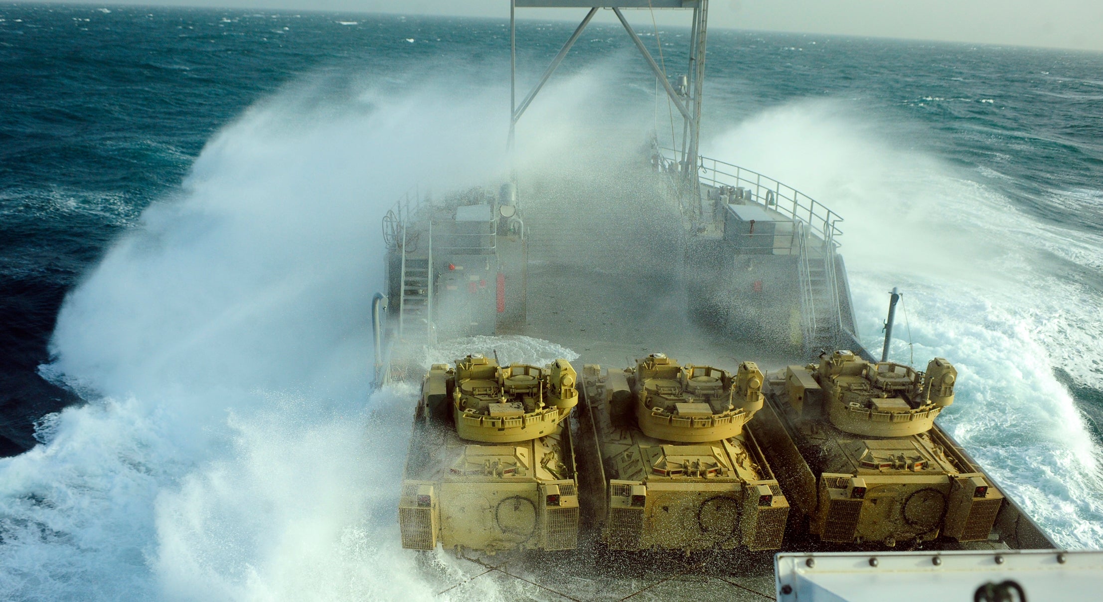 U.S. Army ship transporting Bradley Fighting Vehicles as waves crash over the bow
