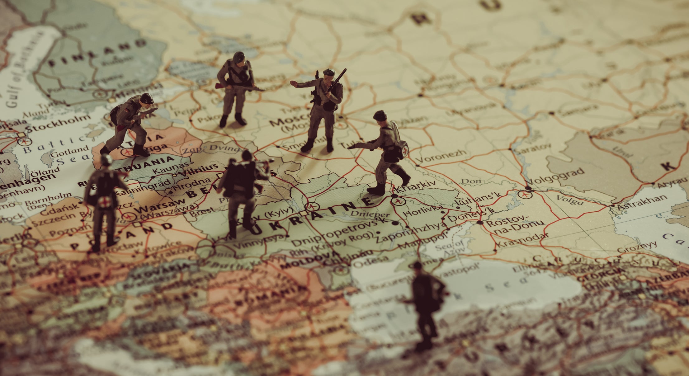 painted model soldiers standing on a map of eastern Europe
