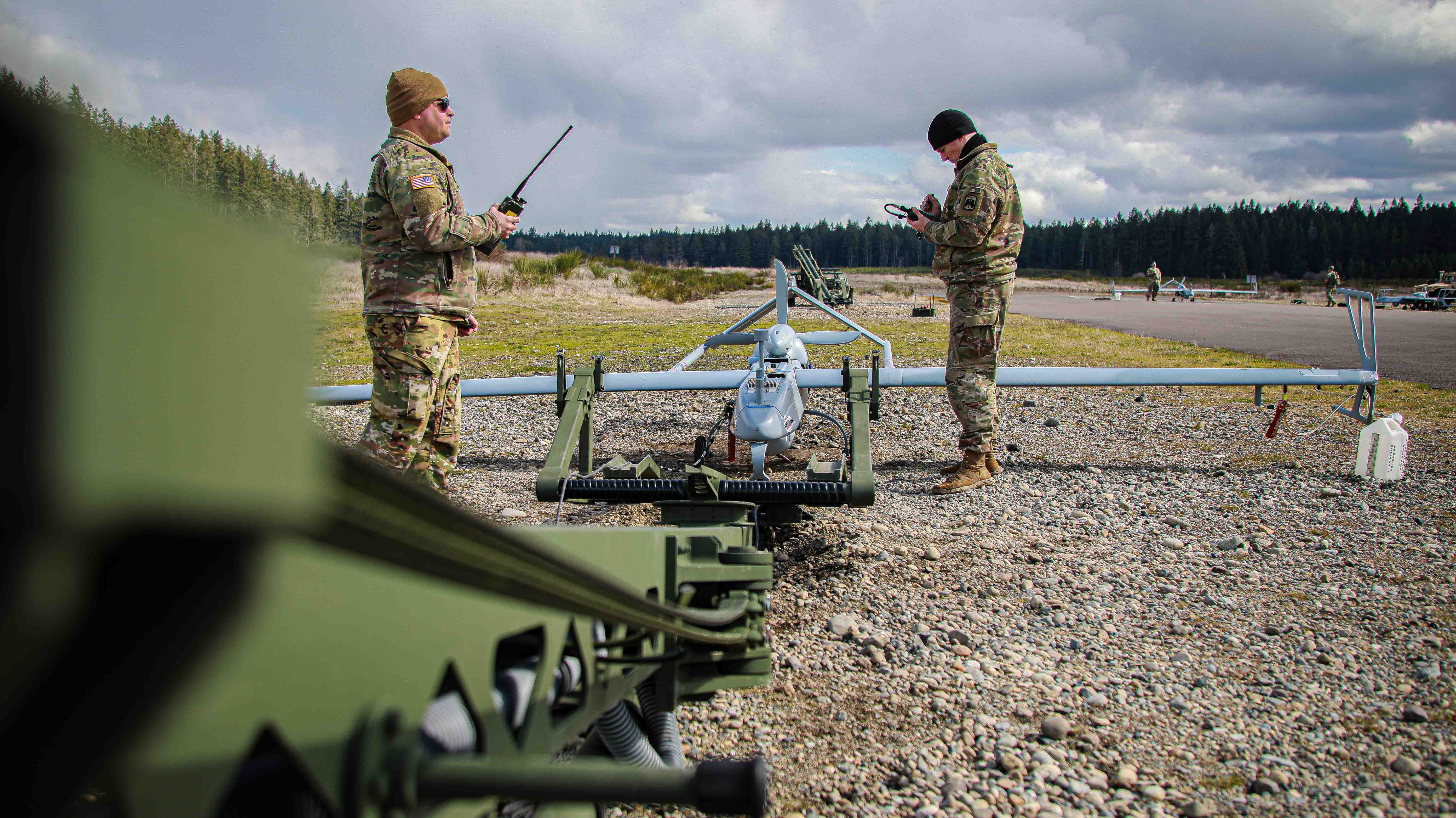 Troopers assigned to 4-6 Air Cavalry Squadron, 16th Combat Aviation Brigade, discuss preflight operations of the RQ-7B Shadow unmanned aerial system, from the training area of Joint Base Lewis-McChord, Wash., April 19, 2023. (U.S. Army photo by Sgt. Ashunteia’ Smith, 16th Combat Aviation Brigade)
