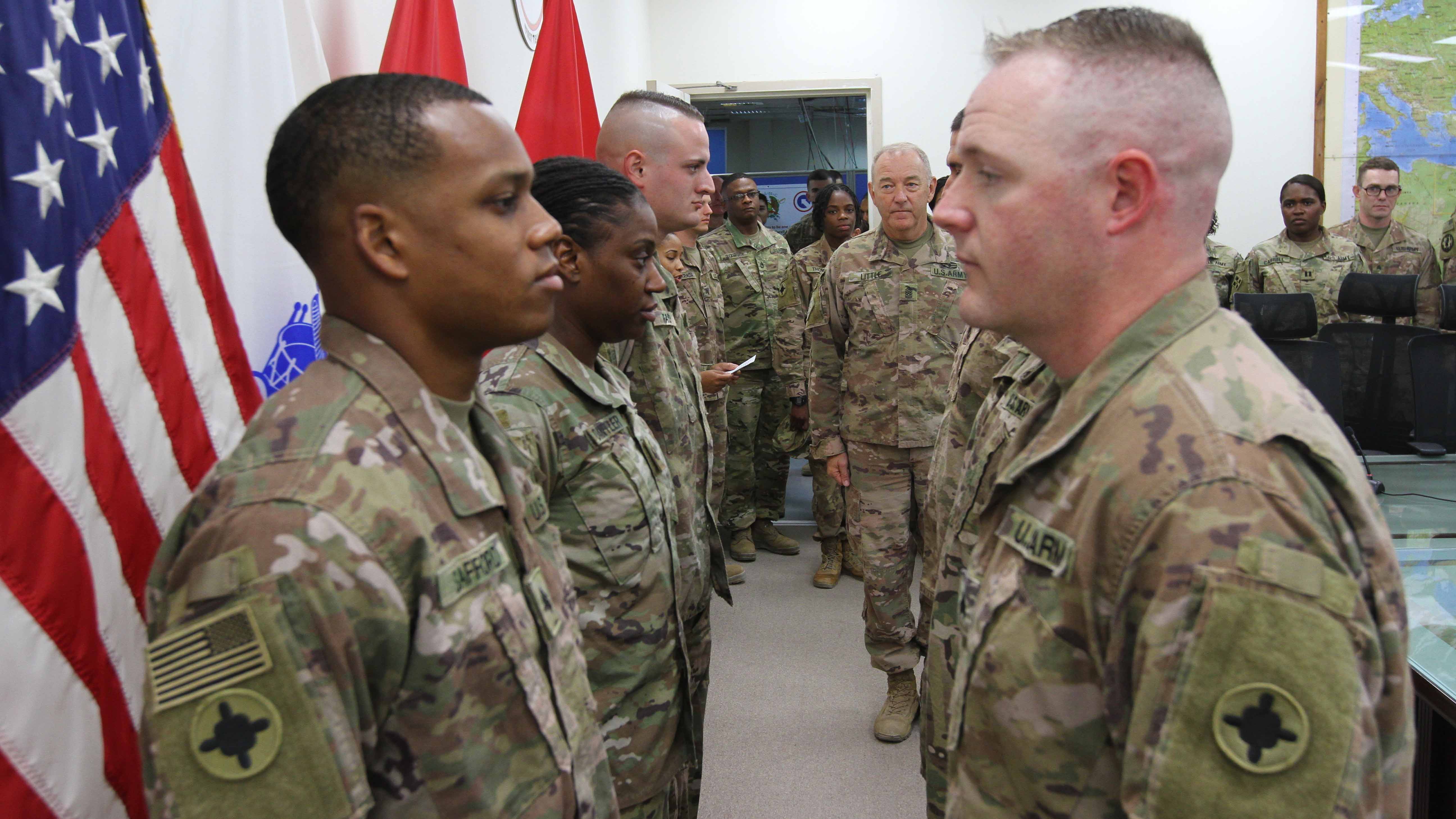 Soliders standing in line to be promoted