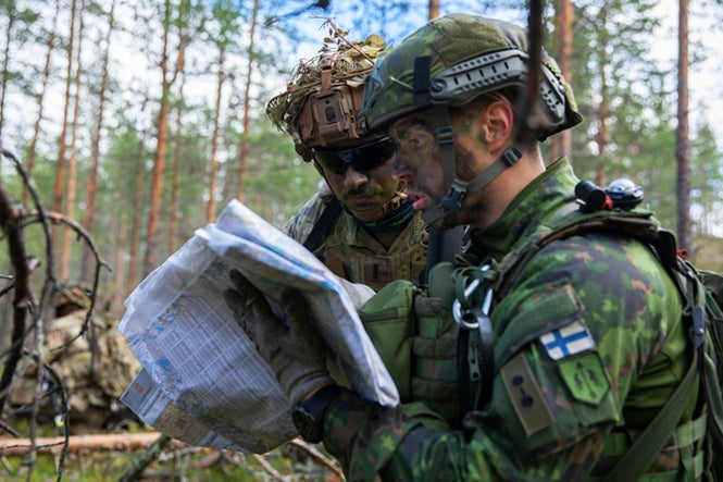 U.S. Soldier coordinates grid points with Finnish soldier during Exercise Ryske 22