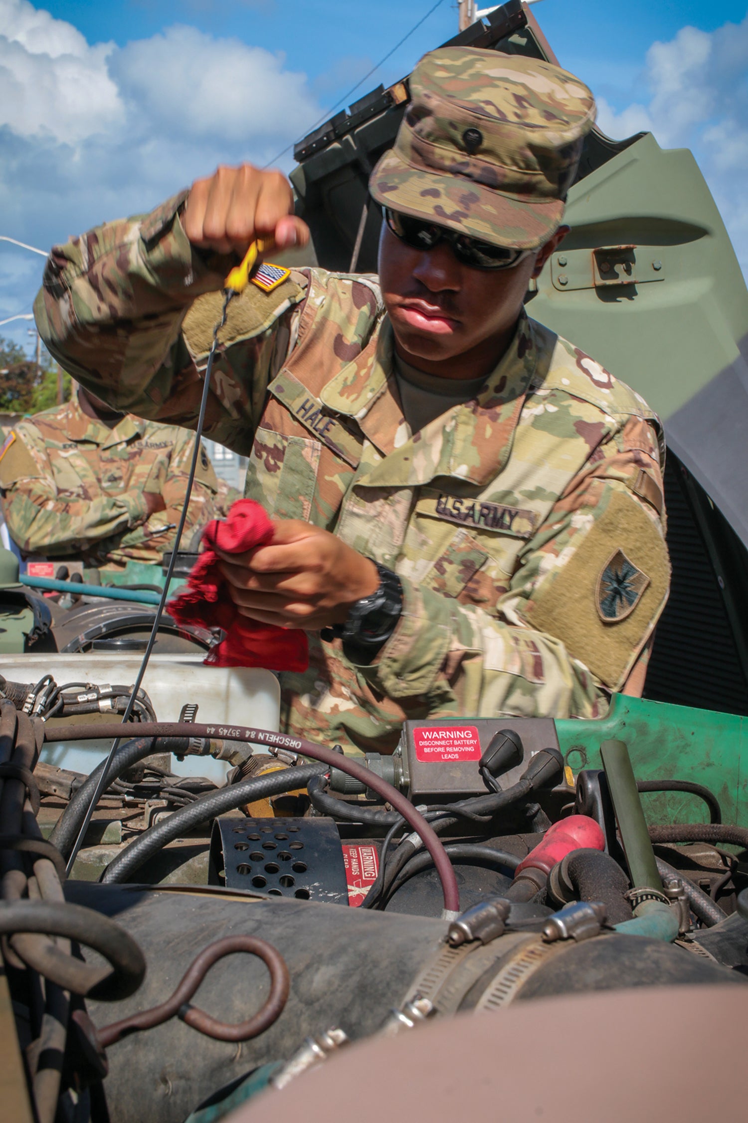 A soldier with the 8th Theater Sustainment Command performs preventive maintenance on a vehicle at Fort Shafter, Hawaii. (Credit: U.S. Army//Spc. Geordan Tyquiengco)