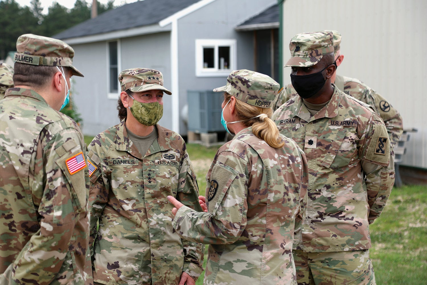 Daniels, second from left, meets with soldiers during an exercise at Fort McCoy, Wisconsin. (Credit: U.S. Army/Sgt. 1st Class Gary Witte)