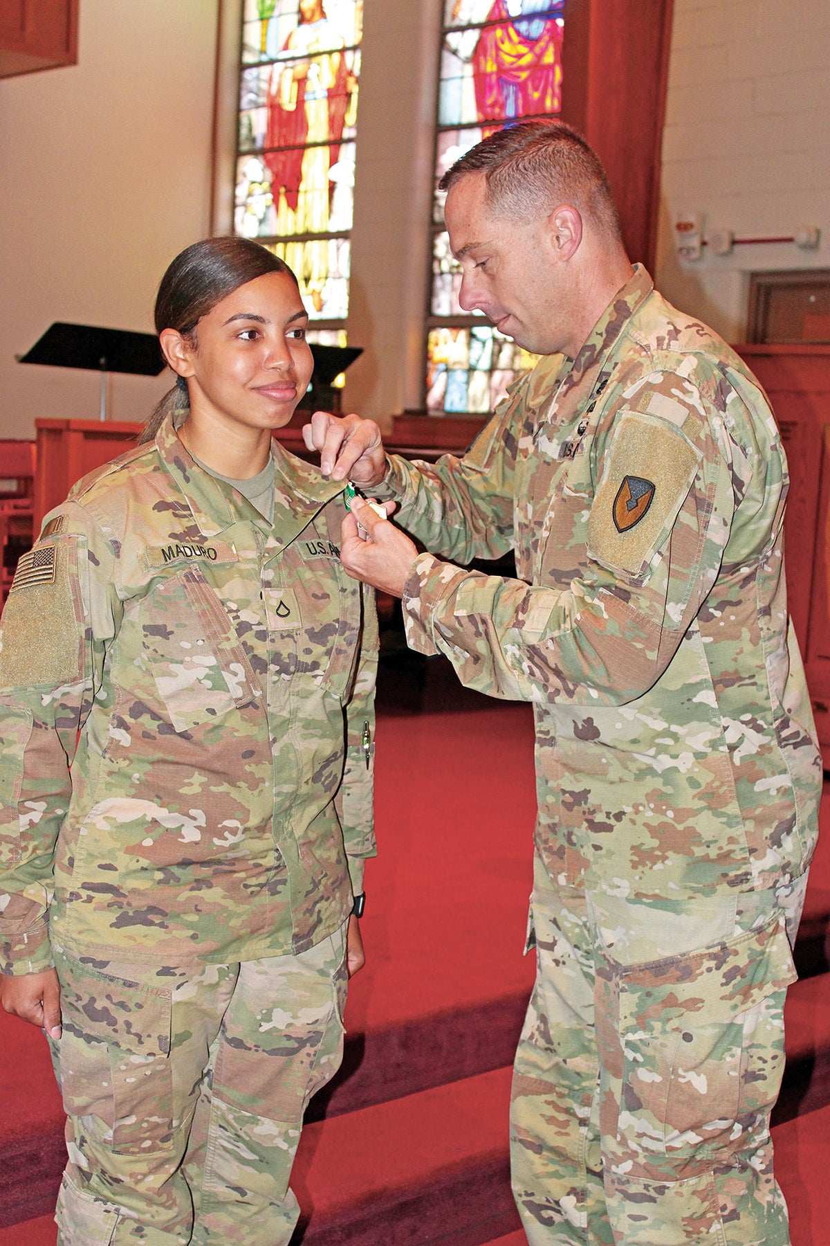Col. Nathan Springer, right, Fort Carson garrison commander, recognizes Pfc. Jumaris Maduro, a religious affairs specialist who helped a family whose house caught on fire. (Credit: U.S. Army/Rick Emert)
