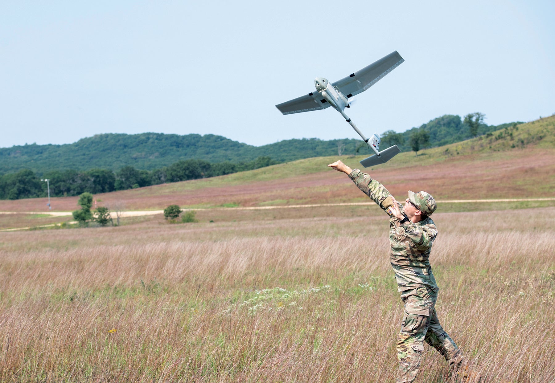 A Wisconsin National Guard soldier launches an RQ-11B Raven small unmanned aircraft system at Fort McCoy, Wisconsin. (U.S. Army/Kevin Clark)