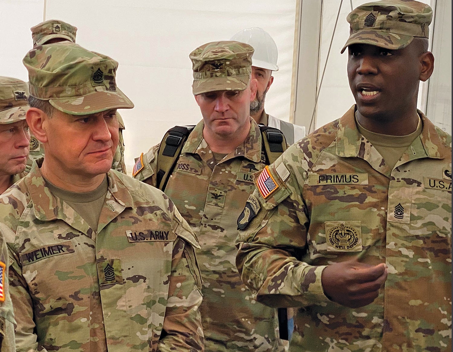 Weimer, left, listens to a briefing from Command Sgt. Maj. Kofie Primus, right, of the 21st Theater Sustainment Command, during a visit to a work site in Mannheim, Germany. (Credit: U.S. Army/Cameron Porter)