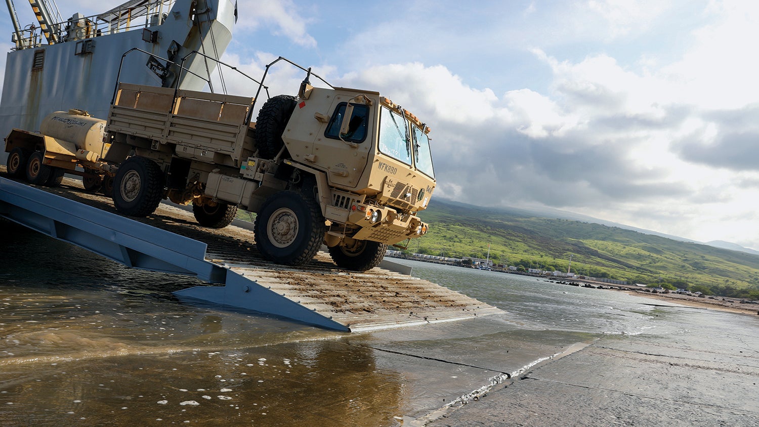 Troops with the 25th Infantry Division unload vehicles from an Army Logistics Support Vessel for a Joint Pacific Multinational Readiness Center exercise in Hawaii. (Credit: U.S. Army/Pfc. Owen Stupcenski)