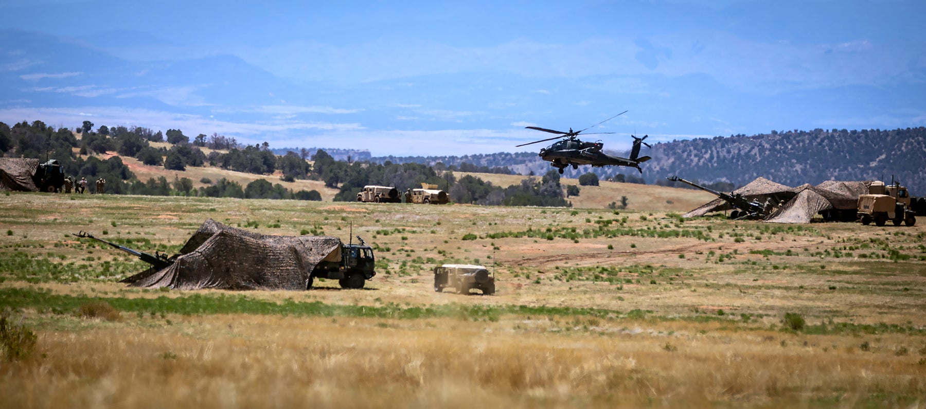 AH-64 Apache helicopters and field artillery work in concert during the 4th Infantry Division’s Ivy Mass exercise at Fort Carson, Colorado, in June. (Credit: U.S. Army/Capt. Alexander Warden) 