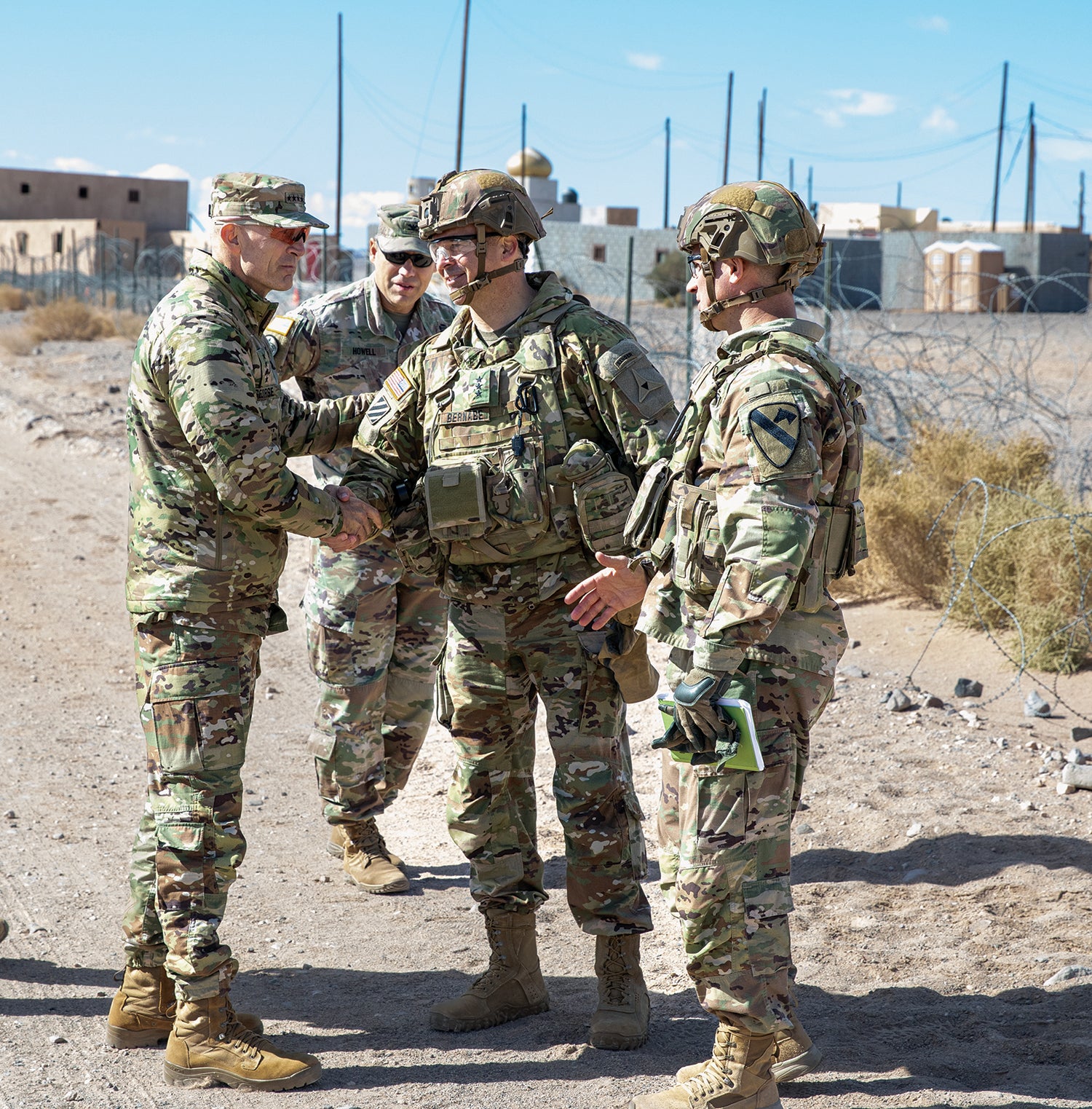 Army Vice Chief of Staff Gen. Randy George, left, shakes hands with Lt. Gen. Sean Bernabe, commanding general of III Corps and Fort Hood, Texas, now known as Fort Cavazos, during a Project Convergence 2022 exercise at Fort Irwin, California. (Credit: U.S. ArmyStaff Sgt. Matthew Lumagui)
