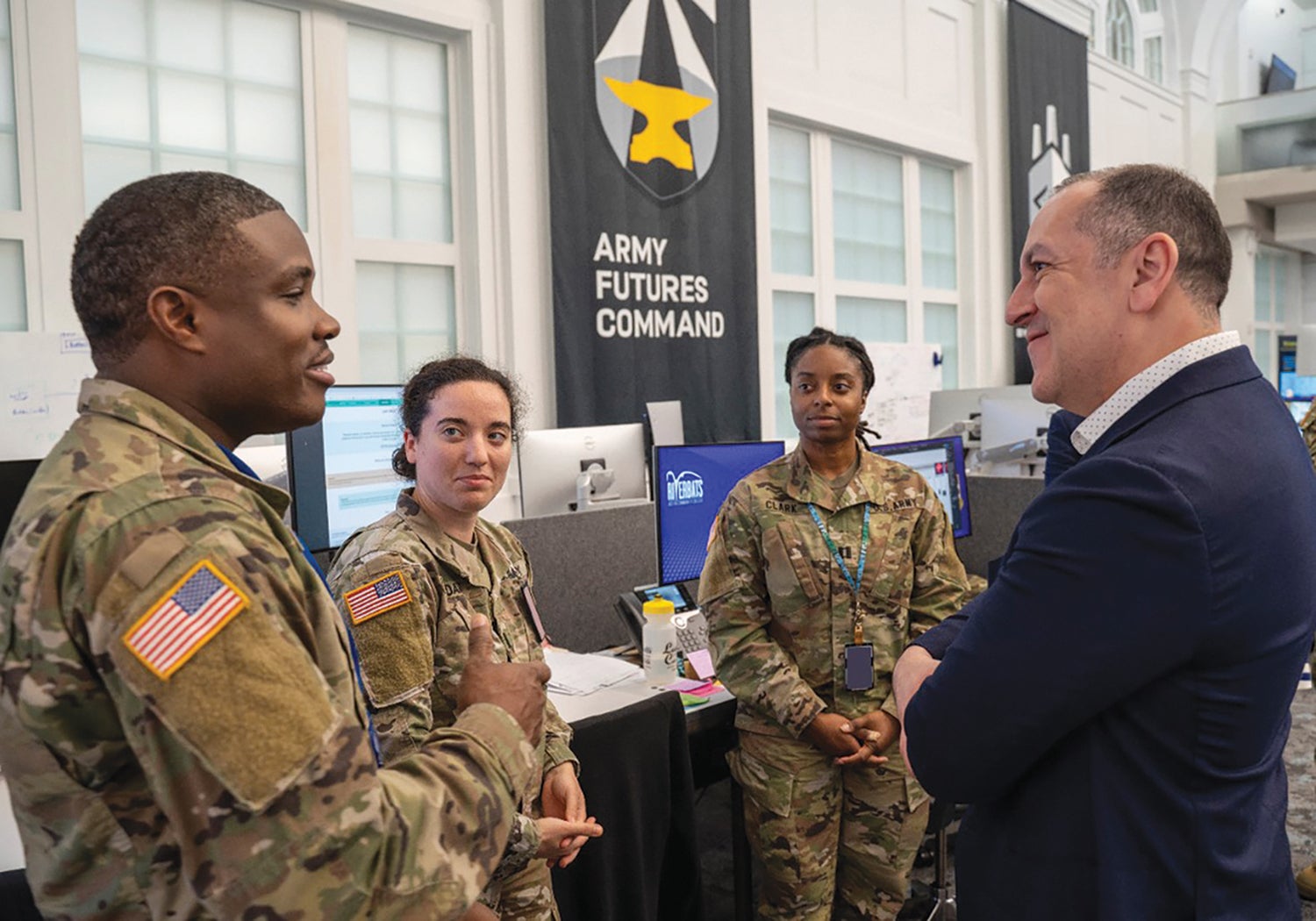 Members of the Software Factory discuss their work with Army Undersecretary Gabe Camarillo, right. (Credit: U.S. Army/Austin Thomas)