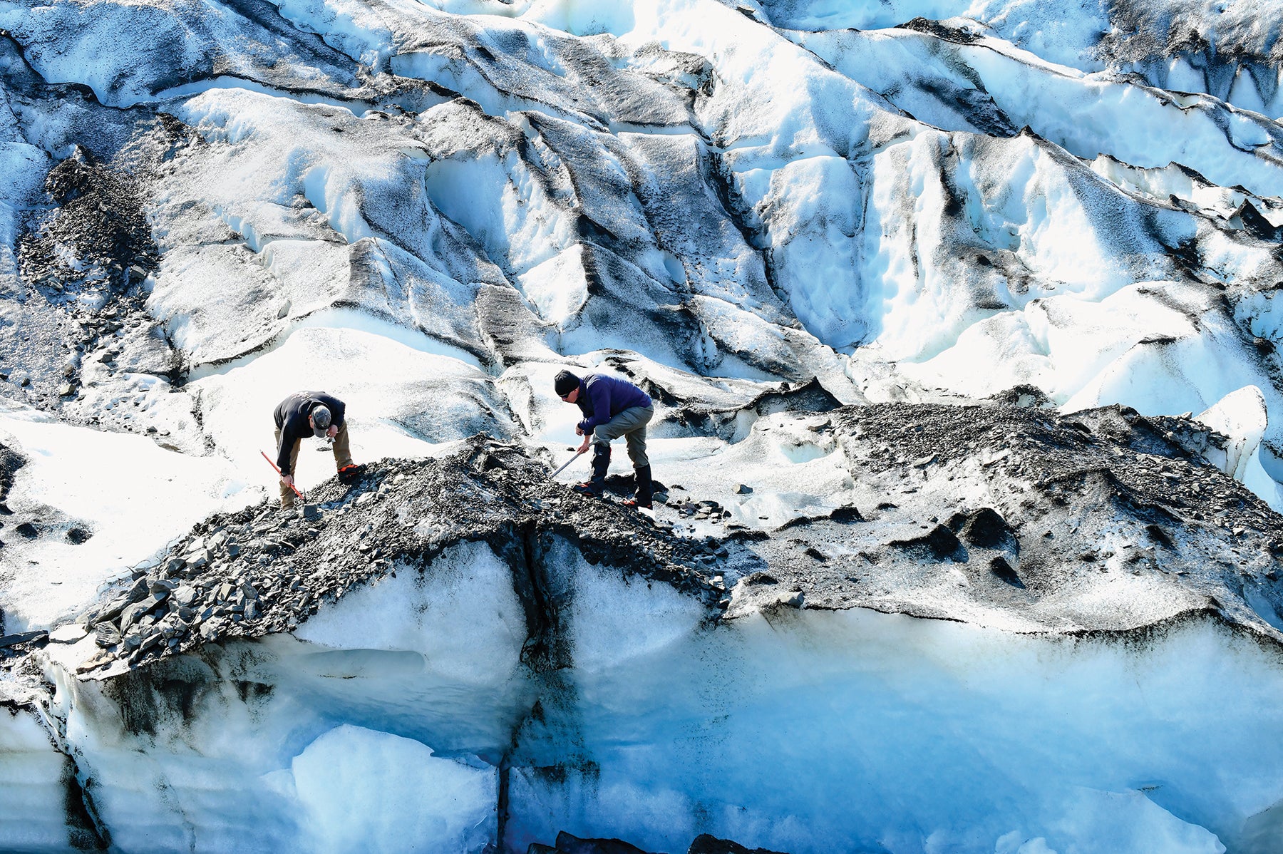 Soldiers from the 2nd Infantry Brigade Combat Team (Airborne), 11th Airborne Division, dig through rocks and debris during a mission on Colony Glacier, Alaska. (Credit: U.S. Army/John Pennell)