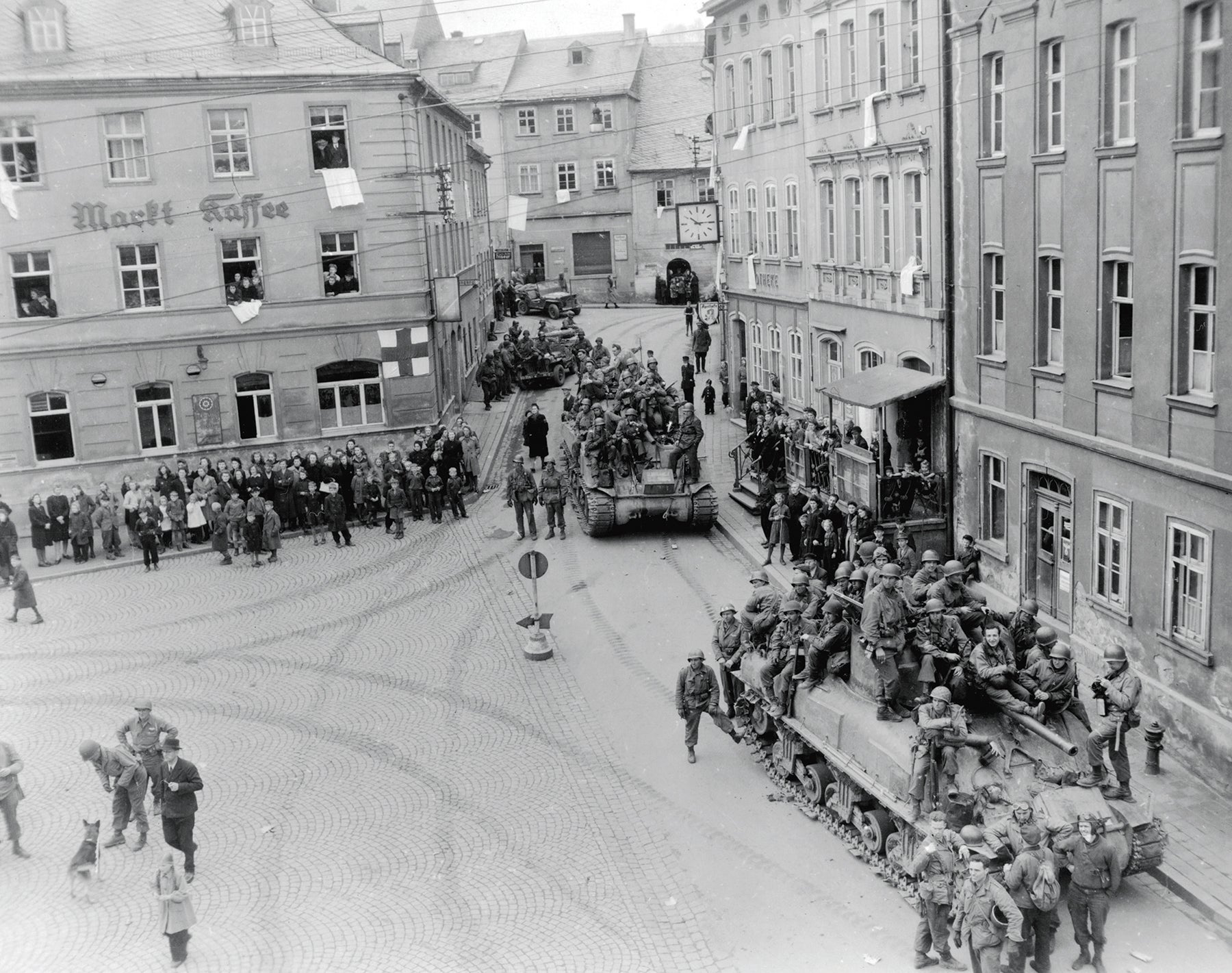 Tanks transport 90th Infantry Division troops through Lobenstein, Germany, in April 1945. (Credit: U.S. Army/Tec 4 James Ryan)