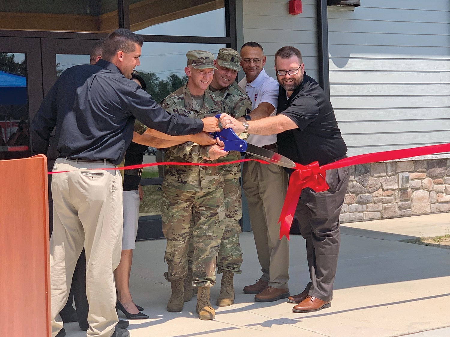 Fort Bragg garrison commander Col. Scott Pence, in uniform on left, and other leaders cut a ribbon to open the post’s Smith Lake Outdoor Recreation Center. (Credit: U.S. Army/Elvia Kelly)