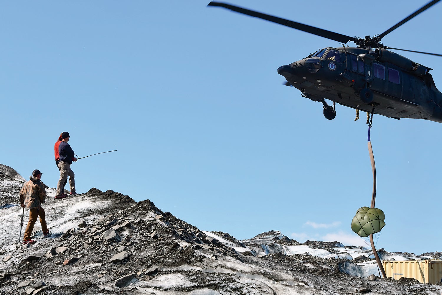 Soldiers work on Colony Glacier, Alaska, assisted by a Black Hawk helicopter from the Alaska National Guard. (Credit: U.S. Army/John Pennell)