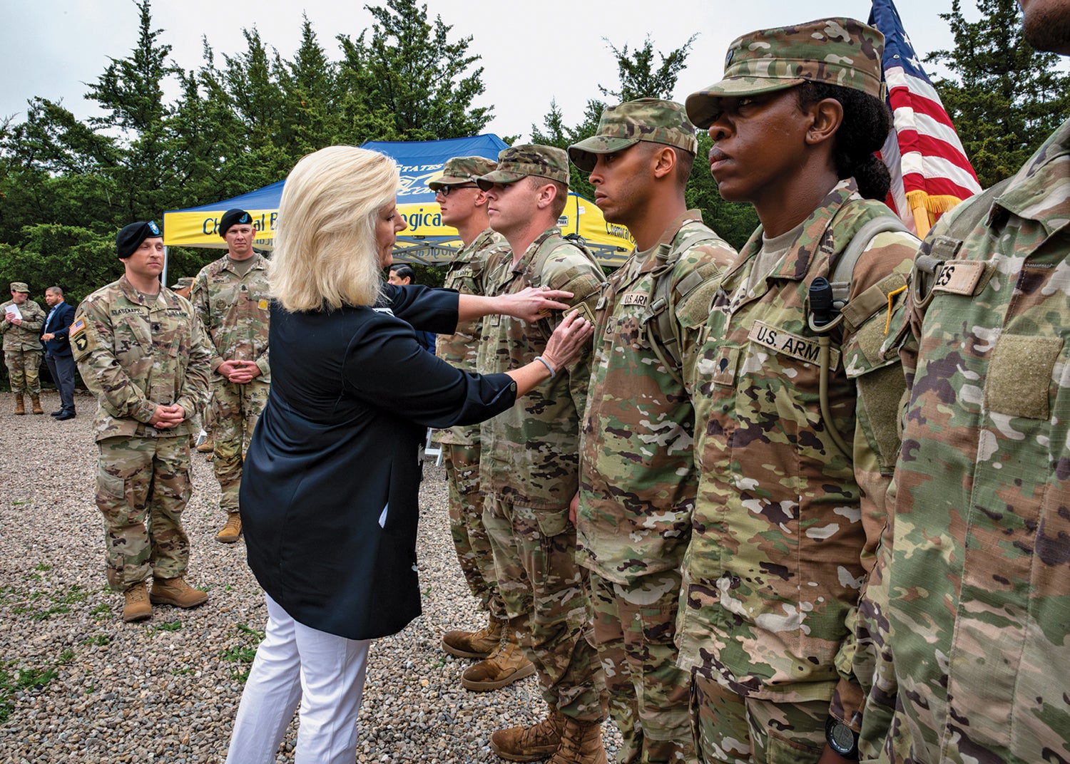 Army Secretary Christine Wormuth puts a patch on a soldier during a rite of passage ceremony at Basic Combat Training at Fort Leonard Wood, Missouri. (Courtesy Photo)