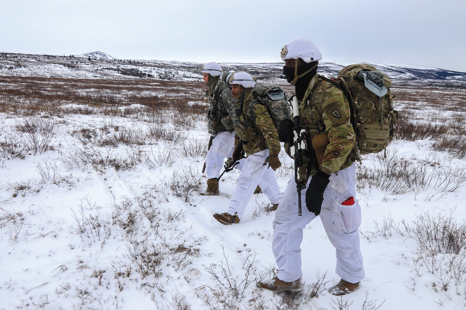 Paratroopers from the 4th Brigade Combat Team (Airborne), 25th Infantry Division, move to their assembly areas after conducting an airborne infiltration near Fort Greely, Alaska. (Credit: U.S. Army/Maj. Jason Welch)