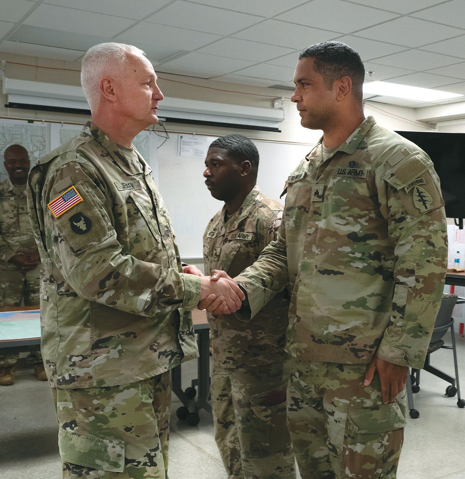Lt. Gen. Jon Jensen, left, director of the Army National Guard, presents a coin to Sgt. Travarus Franklin of the Alabama Army National Guard during an exercise at Camp Grayling Joint Maneuver Training Center, Michigan. (Credit: Army National Guard/ Sgt. 1st Class Jon Soucy) 