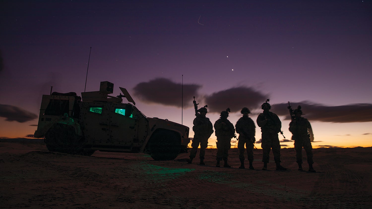 Soldiers with the 2nd Armored Brigade Combat Team, 3rd Infantry Division, stand near their Joint Light Tactical Vehicle at the National Training Center, Fort Irwin, California. (Credit: U.S. Army/Sgt. Dre Stout)