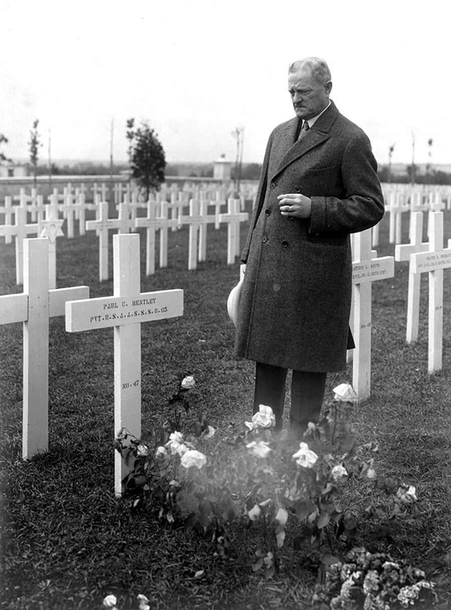 Then-American Battle Monuments Commission Chairman retired Gen. John Pershing visits a grave at Oise-Aisne in 1924. (Credit: American Battle Monuments Commission)