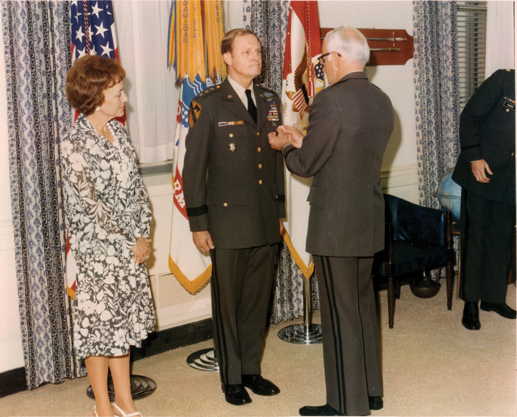 Lt. Gen. Hal Moore, center, retires from active duty in 1977 with his wife, Julie, by his side. (Credit: U.S. Army)