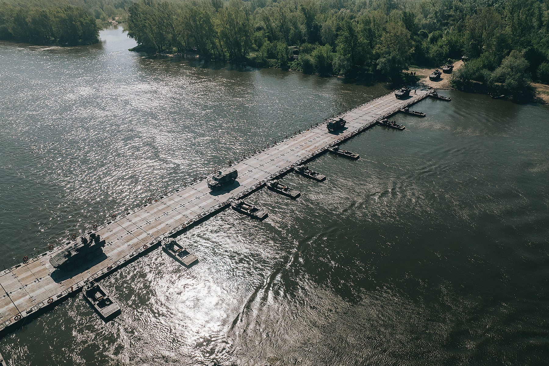 European allies and U.S. troops cross the Vistula River in Poland using a float ribbon bridge constructed from U.S. Army pre-positioned equipment. (Credit: DoD/Michal Czornij)