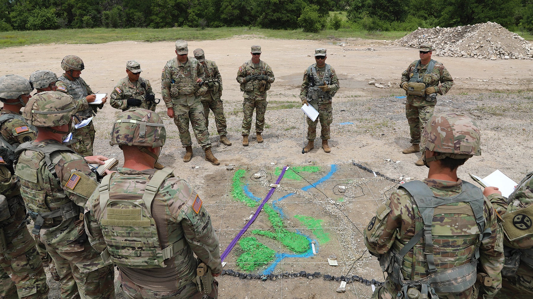 Soldiers with the Tennessee Army National Guard’s 278th Armored Cavalry Regiment gather around a sand table to discuss troop movements as part of an eXportable Combat Training Capability exercise at Fort Hood, Texas. (Credit: Tennessee Army National Guard/Staff Sgt. John Cunningham)