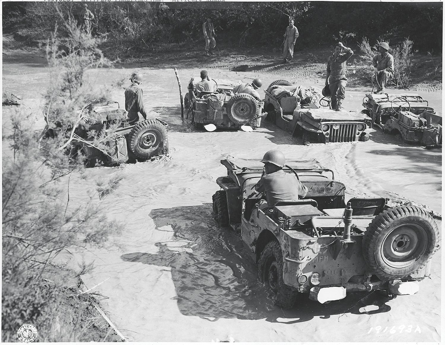 U.S. Fifth Army jeeps cross a rain-swollen stream in Italy during World War II. (Credit: National Archives)