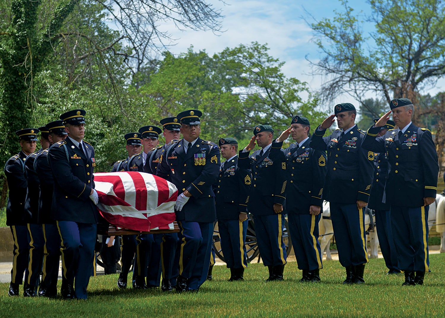 Members of an honor guard and the 5th Special Forces Group (Airborne) escort the casket of Sgt. 1st Class Alan Boyer, who had been missing in action for almost 48 years, during his June 2016 funeral at Arlington National Cemetery.