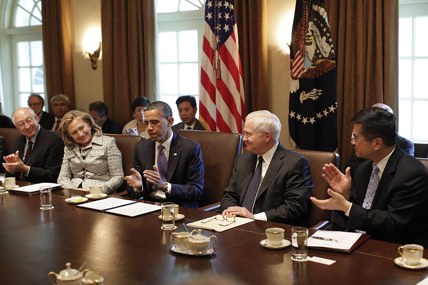 During a Cabinet meeting in May 2011, then-President Barack Obama, second from left, applauds Defense Secretary Robert Gates, third from left, after the successful U.S. raid against al-Qaida leader Osama bin Laden in Pakistan. (Credit: National Archives)