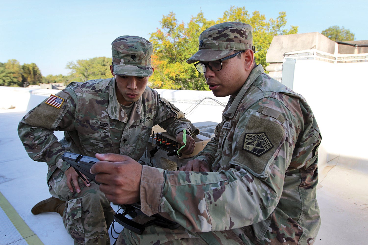 Spcs. Mike Diep, left, and Matthew Scruggs, of the 915th (now 11th) Cyberspace Warfare Battalion, participate in an exercise at Muscatatuck Urban Training Center, Indiana. (Credit: U.S. Army/Steven Stover)