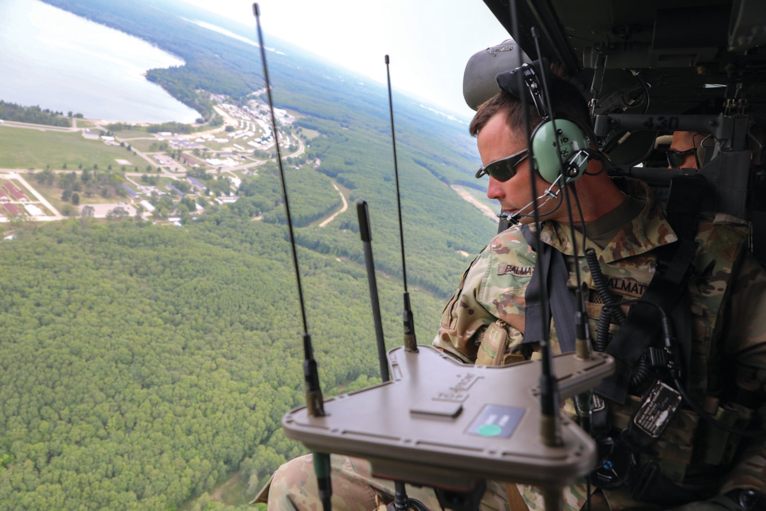 Capt. Tucker Palmatier, a cyber electronic warfare officer with the 37th Infantry Brigade Combat Team, monitors radio equipment at Camp Grayling. (Credit: Ohio Army National Guard/Staff Sgt. Scott Fletcher)